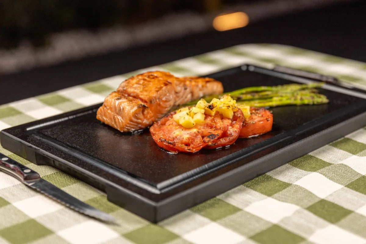 Grilled salmon and vegetables served on a Black PolySlice BBQ HDPE Plate - Perfect for outdoor dining and elegant presentation.