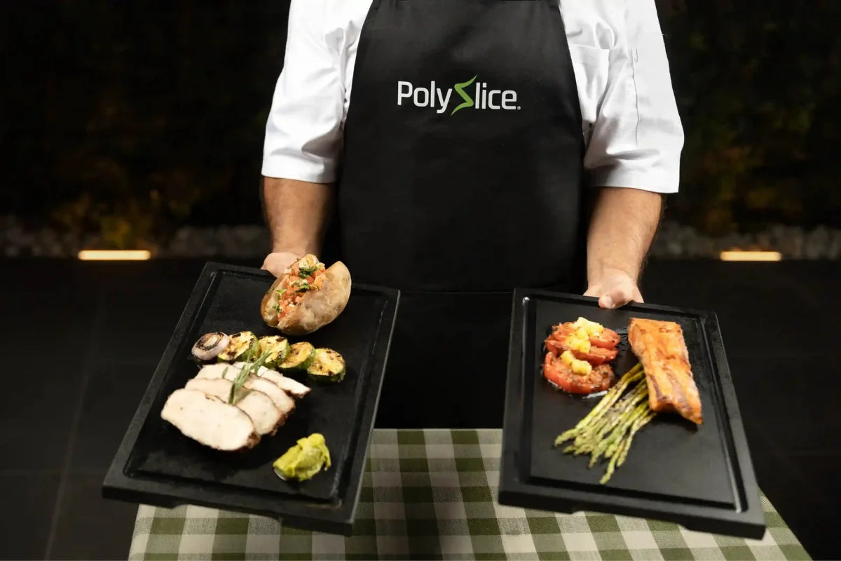 Chef holding two Black PolySlice BBQ Serving HDPE Plates with grilled chicken, salmon, and vegetables - Professional food presentation.