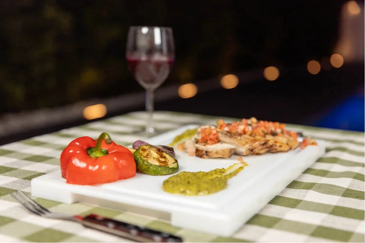 Grilled chicken with vegetables on a White PolySlice BBQ Plate outdoor setup